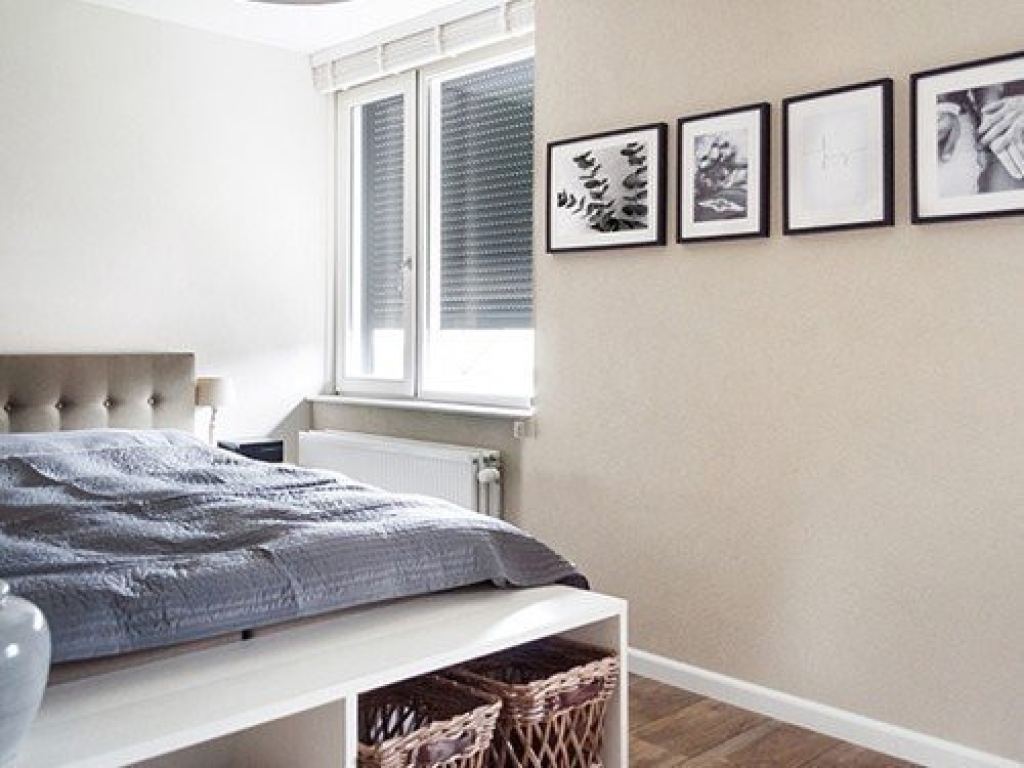 Manually operated roller shutters in a modern bedroom with a calm interior.