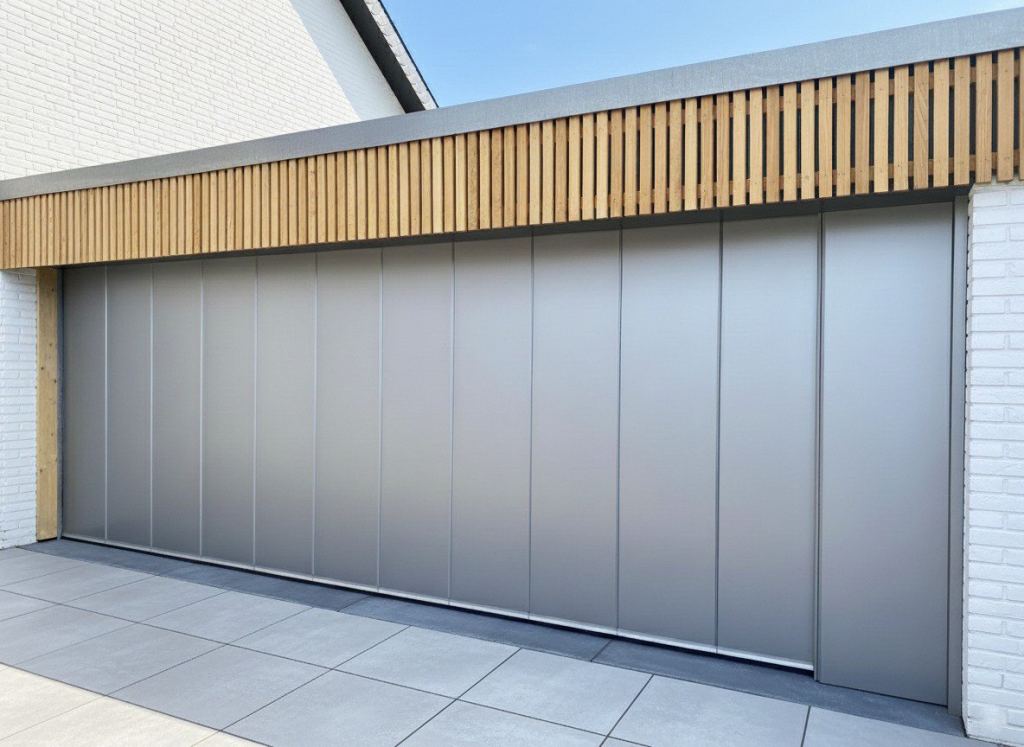 Insulated side-sliding garage door with a sleek design on a modern home in Limburg.