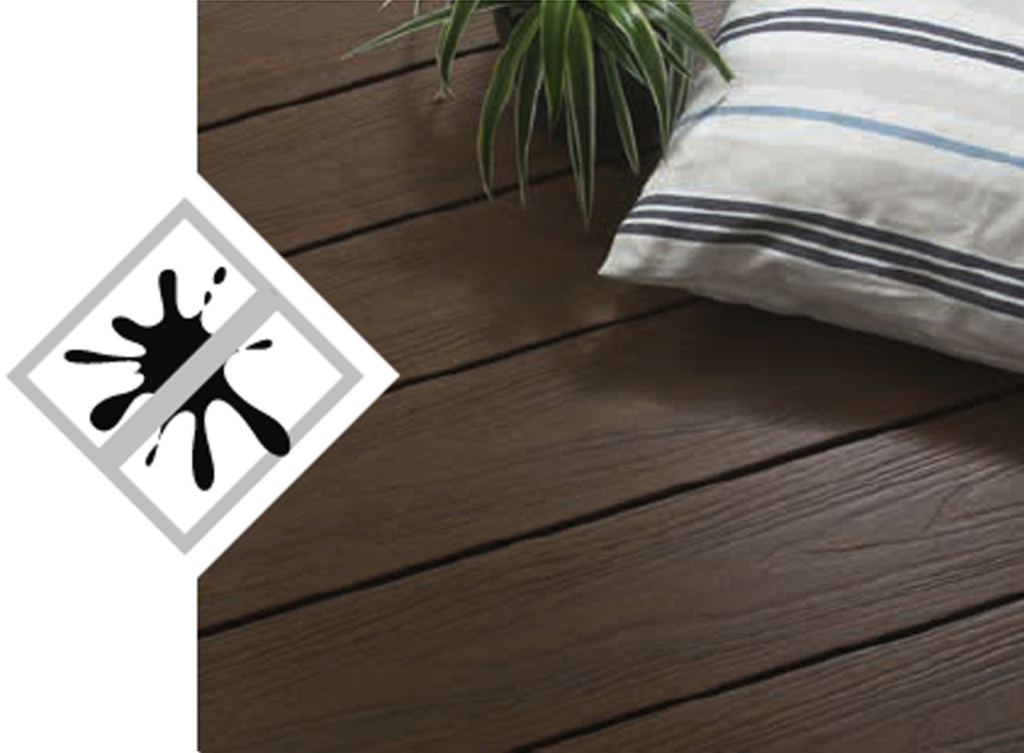 Sustainable, recyclable composite decking in a warm brown shade, with a cushion and a plant, for a stylish outdoor space.