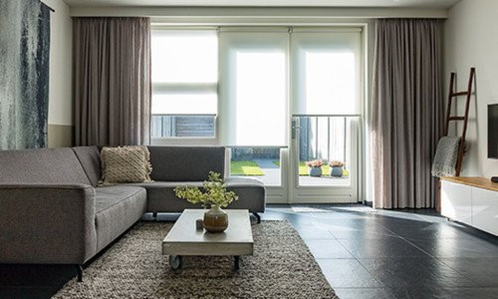 Light-filtering roller blinds in a stylish interior with modern furniture and blackout curtains in Sittard-Geleen, Limburg.